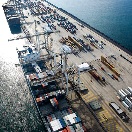 Aerial view of a shipping container sea port. This image is licensed under cc-by-2.0 by attribution. Originally posted to Flickr by Delgoff. at https://www.flickr.com/photos/94038853@N00/2256366262.