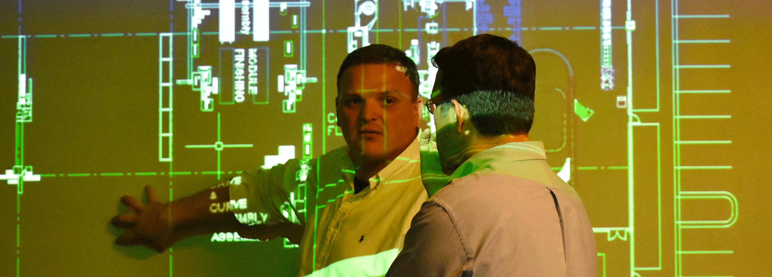 Artistic banner image of two researchers in front of a projector