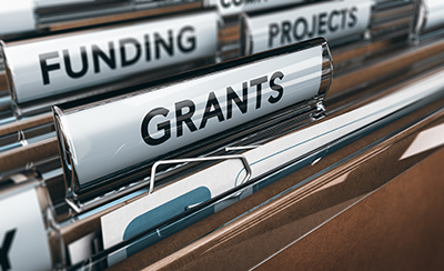 Image-link to Funding Opportunities. File folders in a drawer with big labels including "Grants," "Funding," and "Projects."