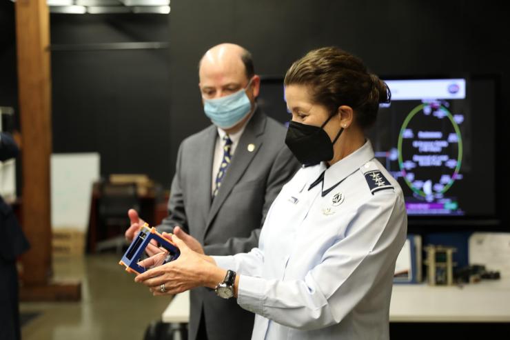 <p>Lt. General Nina Armagno holds cubesat designed by the Space Systems Design Lab’s lab, led by professor Glenn Lightsey.</p>