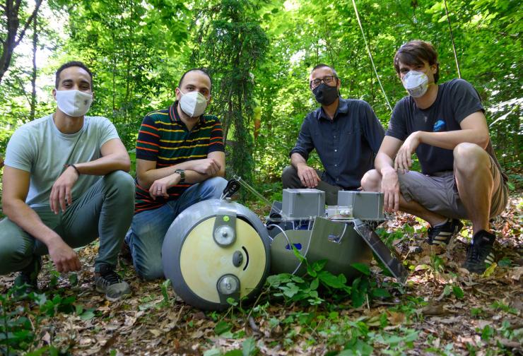 <p>Georgia Tech researchers prepare to install the SlothBot at the Atlanta Botanical Garden. Shown are graduate research assistants Yousef Emam and Gennaro Notomista, Professor and School Chair Magnus Egerstedt, and Research Engineer Sean Wilson. (Credit: Rob Felt, Georgia Tech)</p>