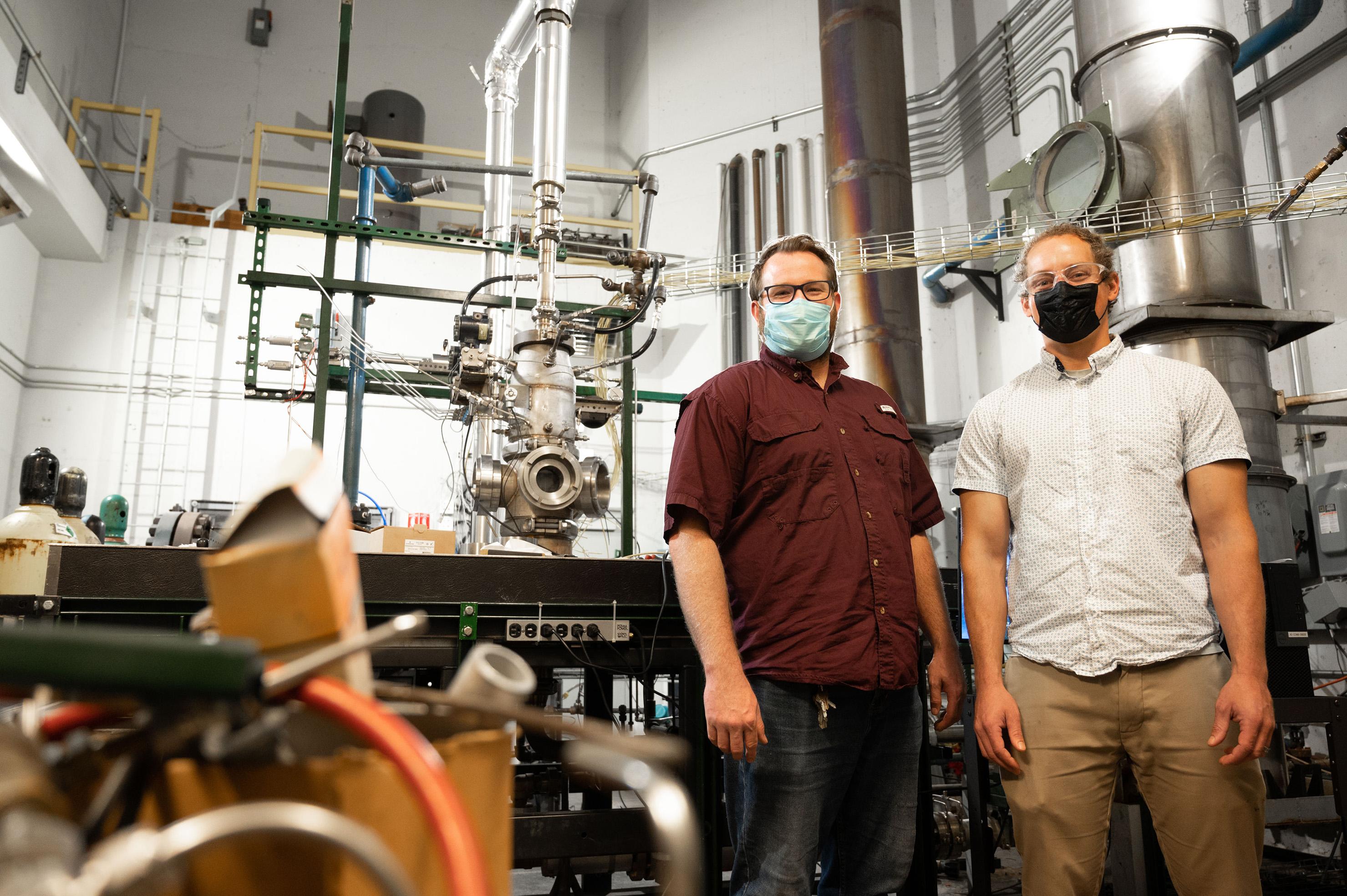 Kristopher Manion, lab manager, and Ben Emerson, research engineer, stand in front of a combustion experiment at the Ben T. Zinn Combustion Lab. Image Credit: Allison Carter/Georgia Tech