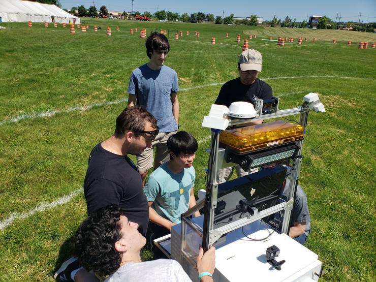 <p>The RoboJackets' IGVC software team members test their code on the course. (Credit: RoboJackets)</p>