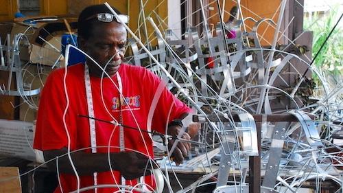 <p><em>An artisan from Trinidad and Tobago uses traditional skills to build an intricate wire frame that will support a large, elaborate Carnival costume. </em></p>