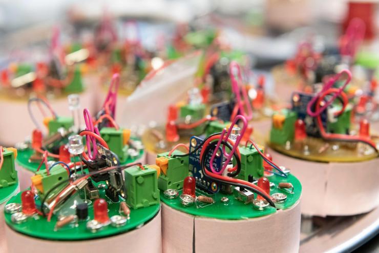 <p>These simple vibrating robots have weak magnetic interactions that encourage cohesion. (Photo: Allison Carter, Georgia Tech)</p>