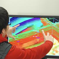 A researcher manipulates a 3-D rendering of subterranean seismic survey data.
