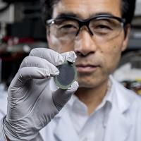 IMat researcher Meilin Liu holds up a low-cost, highly efficient reversible solid oxide cells (H-rSOC) device for hydrogen and electricity generation.