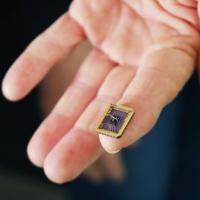 A tiny graphene device on a silicon carbide substrate chip. The device rests on a person's fingertip. Credit: Jess Hunt-Ralston, Georgia Tech 