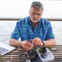 <p>Russell Clark assembling a sea level sensor on Georgia coastline</p>