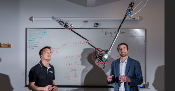 GTRI Research Engineer and ME Professor at work on a swinging robot