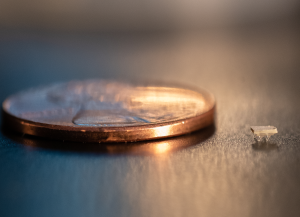 A micro-bristle-bot next to a US penny for scale.